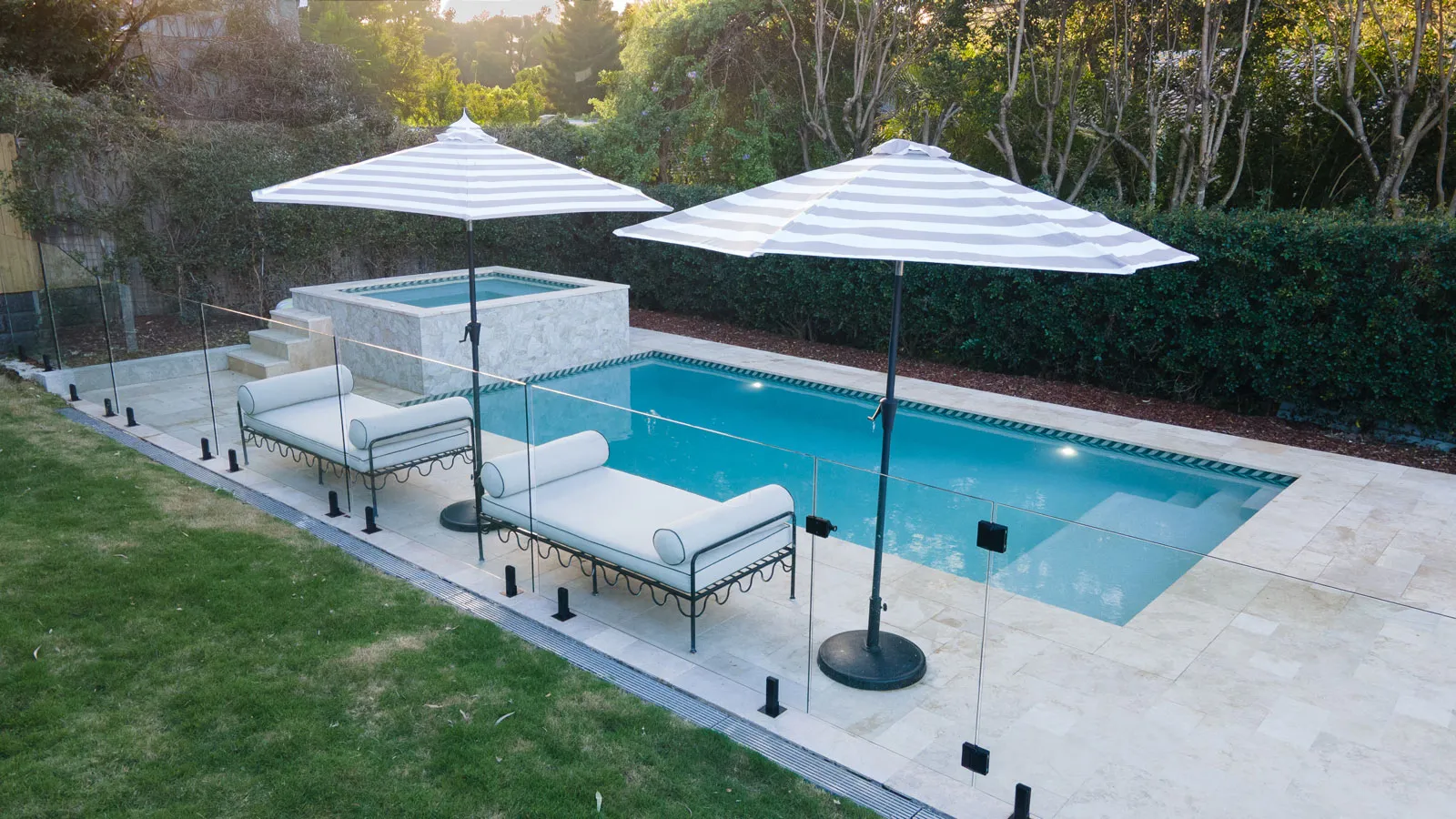 Custom LuxRo pool beside a modern Brisbane home at dusk