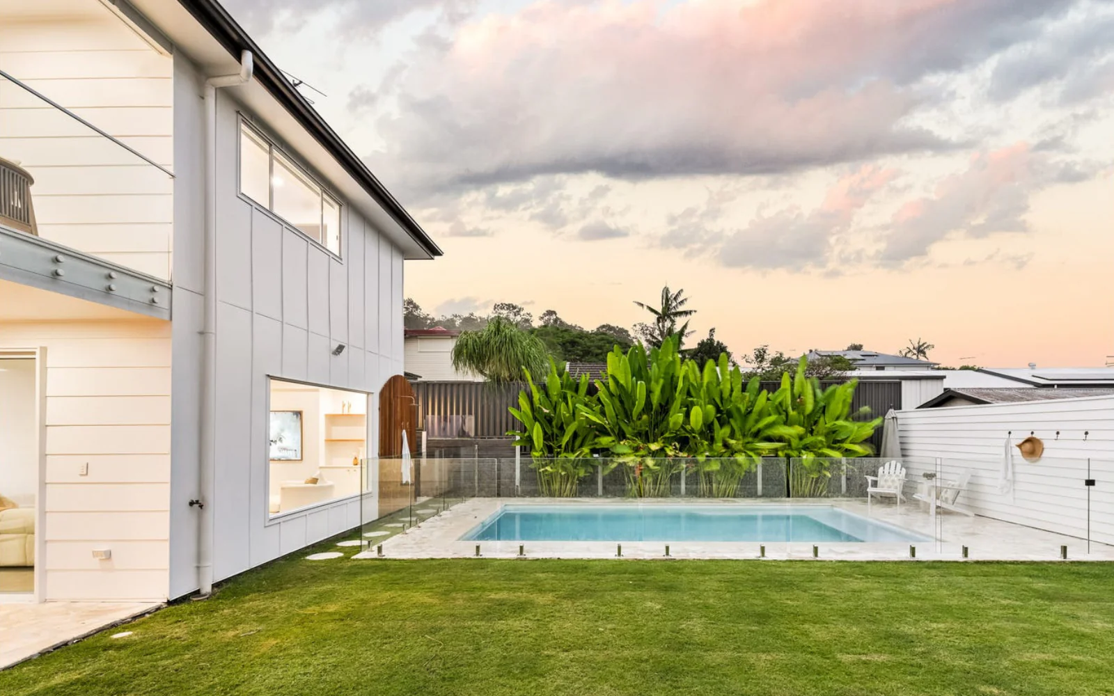 Custom pool at dusk beside a modern Brisbane home